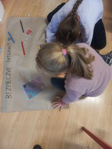 Dziewczynki wykonują plakat „Zasady bezpiecznego korzystania z Internetu”