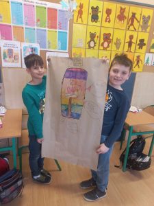 Chłopcy trzymają wykonany własnoręcznie plakat „Zasady bezpiecznego korzystania z Internetu