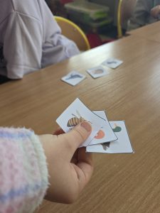 dziecięca dłoń trzymająca obrazki zwierząt